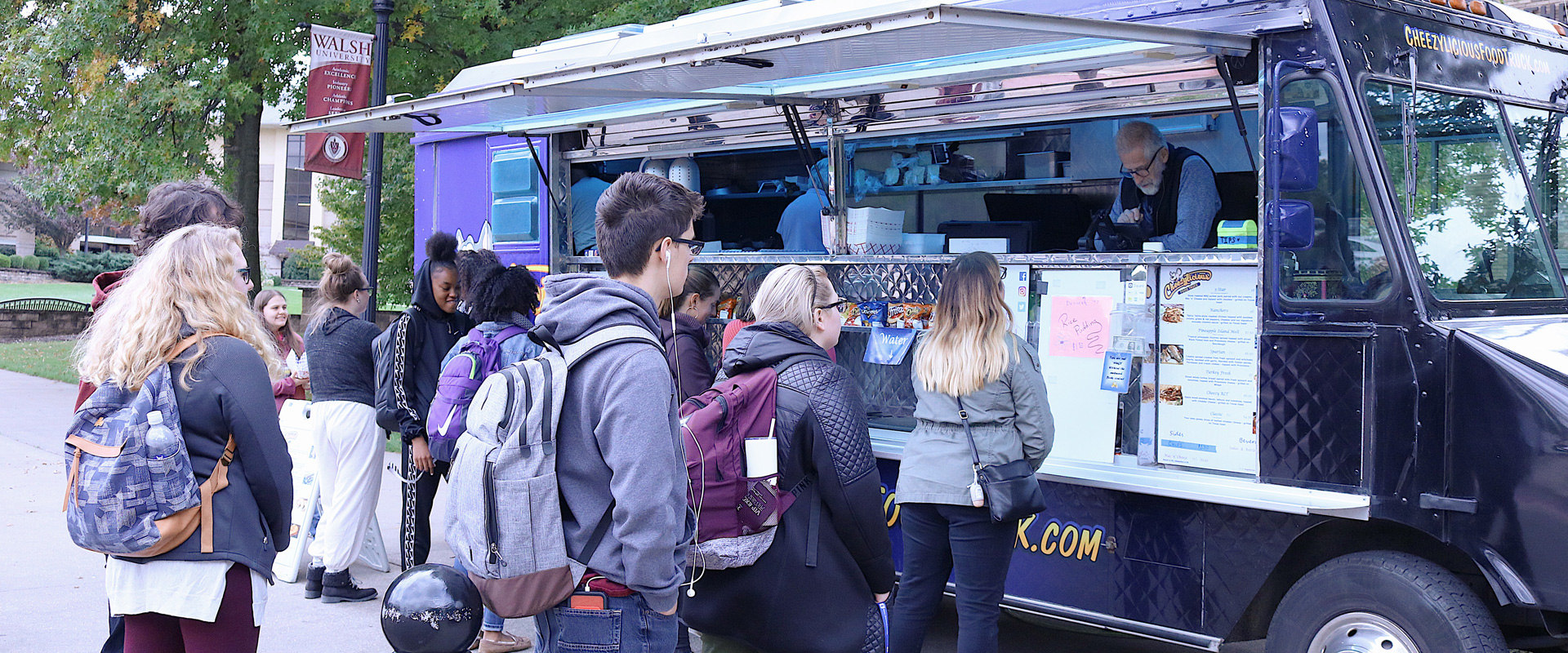 photo of Walsh students in line at a food truck on campus