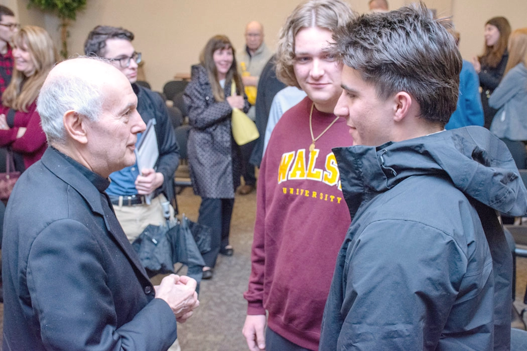 photo of Archbishop Caccia speaking to students