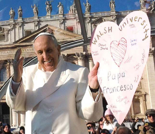 photo of the Pope holding a card made by Walsh University students