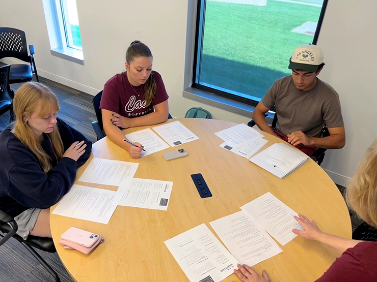 Group of students participating in a resume writing workshop